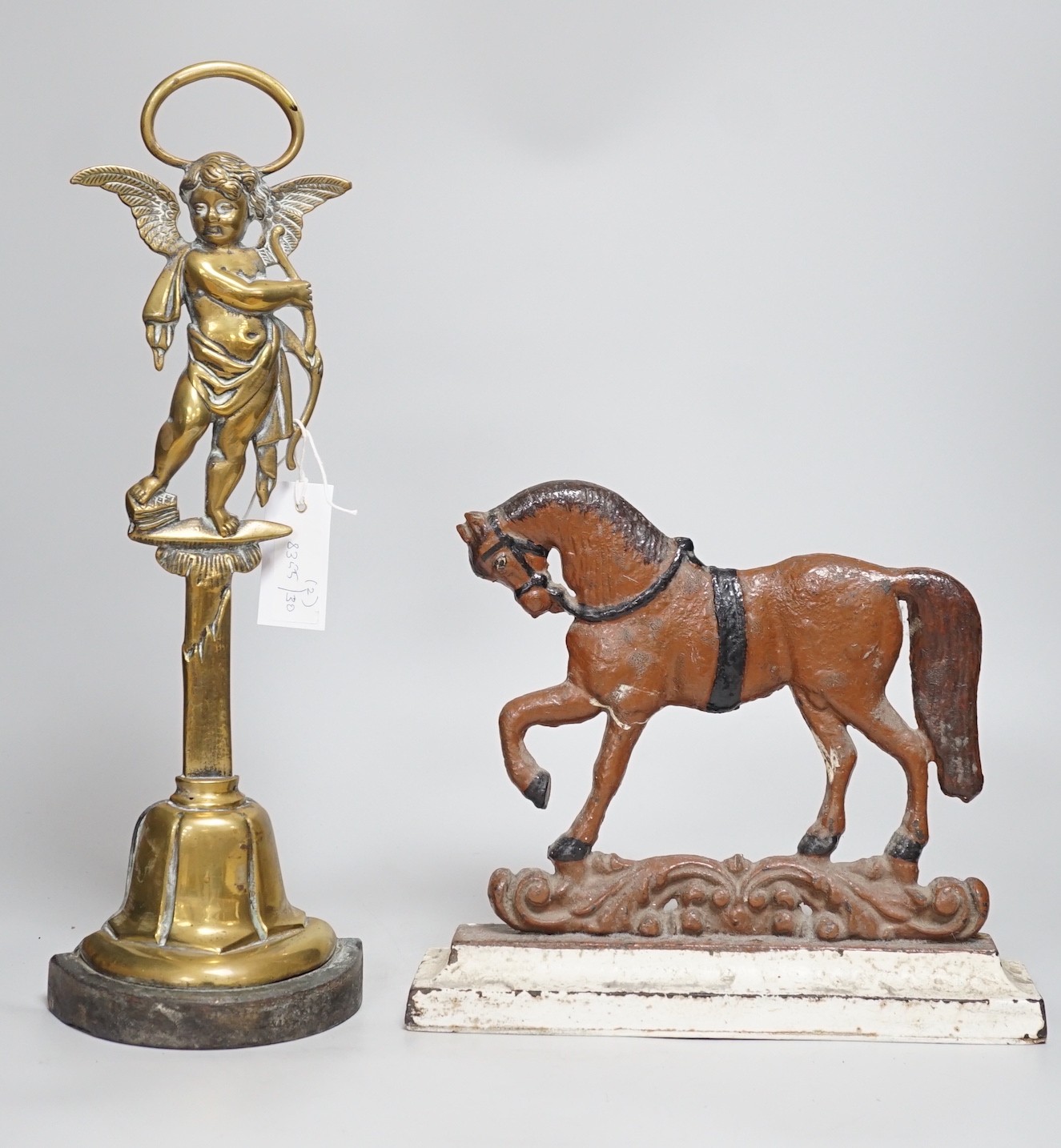 A Victorian bronze cherubic door stop, 45cm, and another painted equine door stop